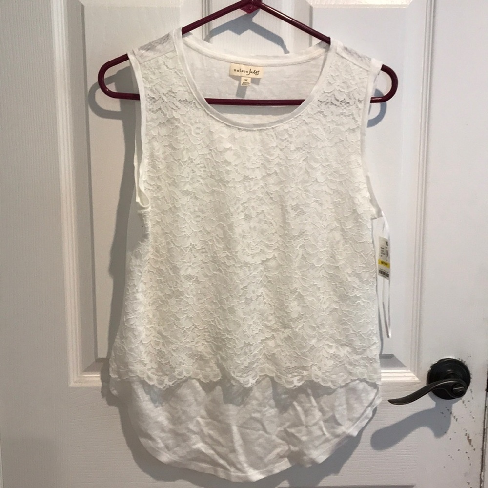 White sleeveless shirt with lace overlay.